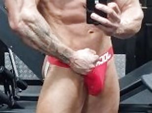 Ripped bodybuilder flexing hard oiled muscles  muscle worship
