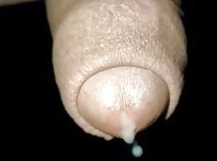 Close up slow motion - Cum dripping out of uncut cock