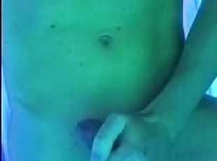 Fit man jerks off in tanning bed