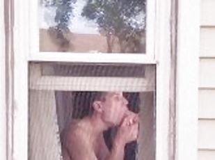 Neighbor Twink using dildo on ass and mouth in window