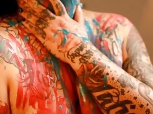 beautiful tattooed girl with paint strokes