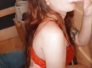 Redhead gives blowjob on her dildo