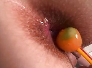 Orange lollipop ???? is playing with my anal and tearing to get inside